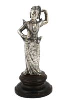 A Burmese cast silver model of a dancer, late 19th century, on an ebonised wood plinth, total height