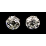 A pair of early 20th century platinum and claw set diamond ear studs, the Old European cut stones