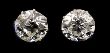 A pair of early 20th century platinum and claw set diamond ear studs, the Old European cut stones