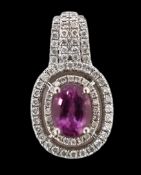 A modern 14ct white gold, pink sapphire and diamond set oval cluster pendant, with four row
