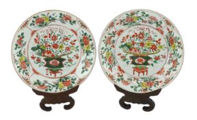 A pair of Chinese famille verte dishes, Kangxi/Yongzheng period, each painted with a basket of