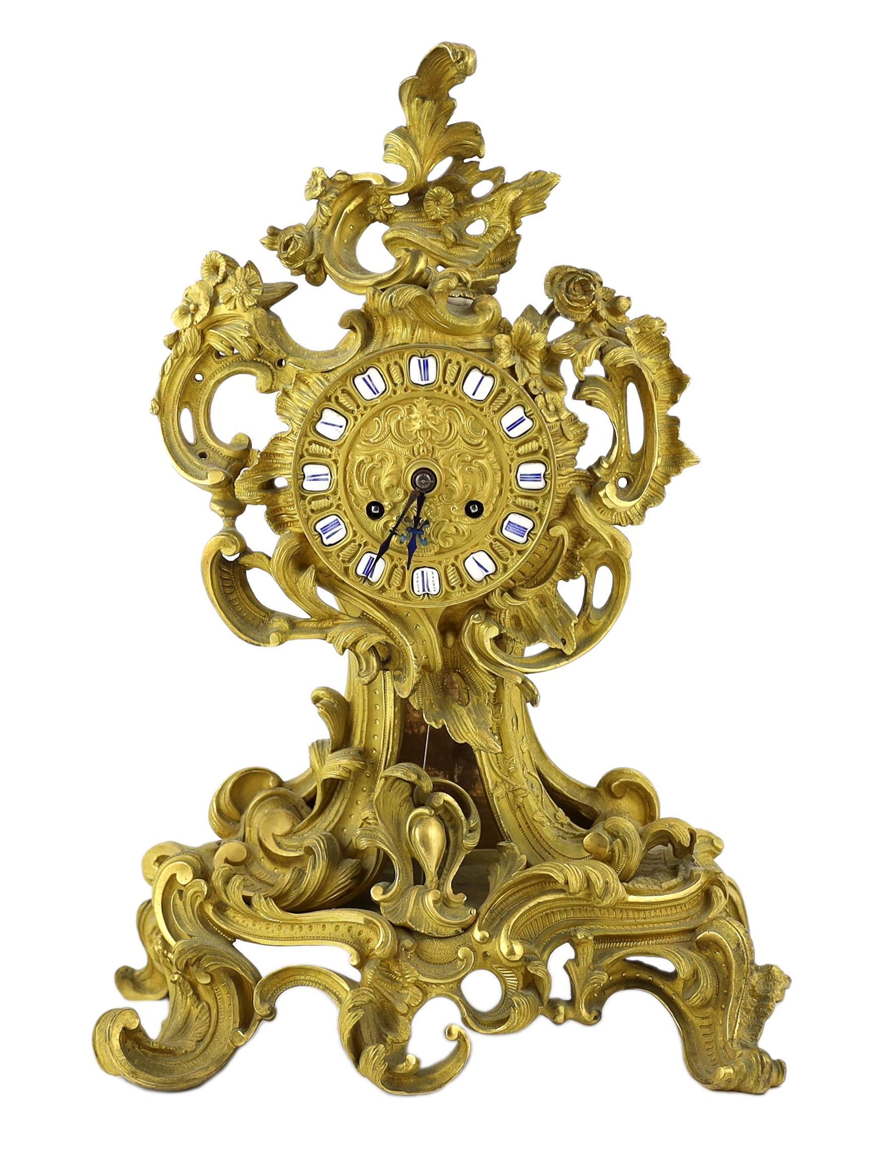 A 19th century French ormolu mantel clock, of asymmetrical scroll form, with enamelled tablet