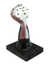 ** A Murano Vetreria amethyst glass arm, holding a white, black spotted, dice in hand, signed,