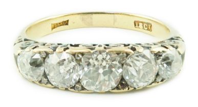 An early 20th century 18ct gold and graduated five stone old cut diamond set half hoop ring, with