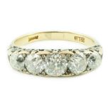 An early 20th century 18ct gold and graduated five stone old cut diamond set half hoop ring, with