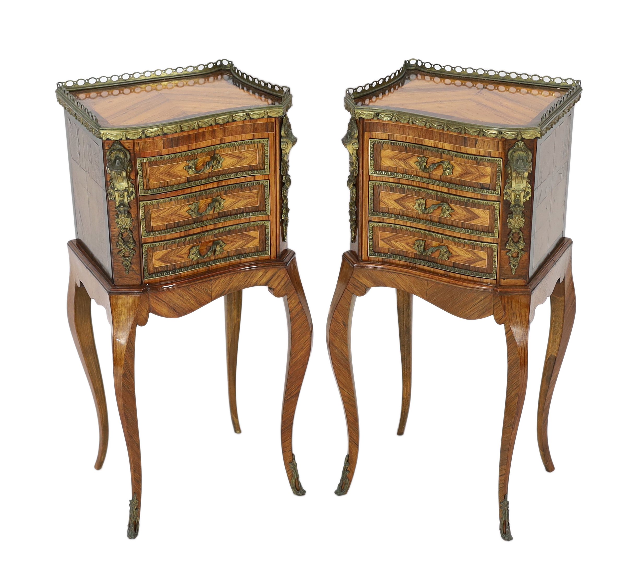 A pair of Louis XVI style ormolu mounted kingwood bedside chests, each of asymmetrical scroll form