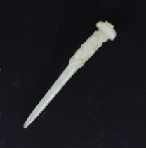 * A Chinese pale celadon jade hair pin, Qing dynasty, carved in relief with a bird on a pine