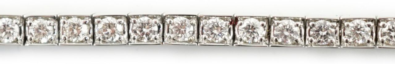 A late 20th century Cartier 18ct white gold and diamond set line bracelet, set with sixty one