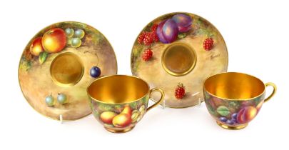 A pair of Royal Worcester fruit painted tea cups and saucers, 1960s, the cups signed J. Smith and E.