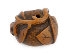 * A Japanese carved wood netsuke of a pumpkin with a stalk and leaves, 19th century, signed