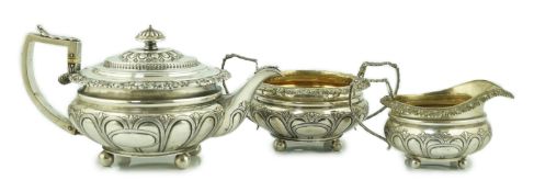 A George IV silver three piece tea set, by William Bateman, of squat circular form, with lobed and