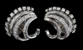 A pair of platinum? and diamond cluster set scrolling earrings, set with graduated rows of round and