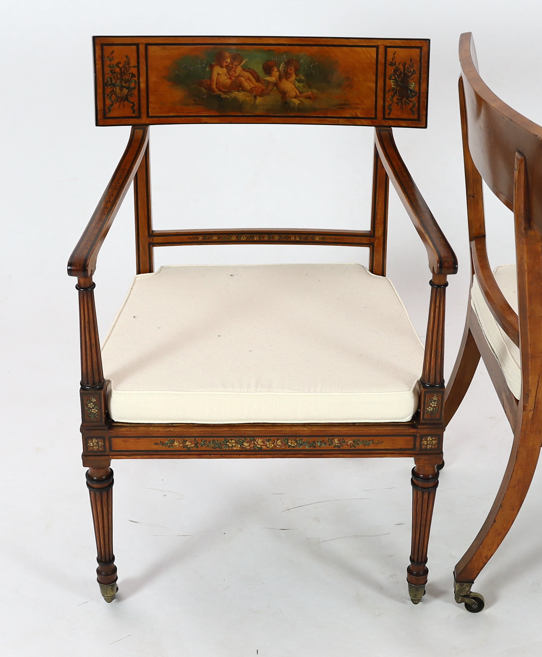 A pair of Edwardian Sheraton revival painted satinwood elbow chairs, decorated with cherubs, flowers - Image 2 of 4
