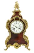 An early 20th century French ormolu mounted red tortoiseshell eight day mantel clock, of Louis XVI