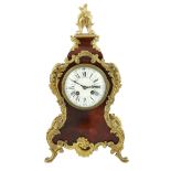 An early 20th century French ormolu mounted red tortoiseshell eight day mantel clock, of Louis XVI