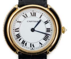 A lady's 18ct gold, black onyx and diamond set Cartier Vendome manual wind wrist watch, with Roman