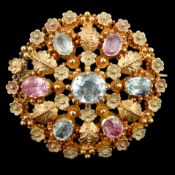 An early 20th century continental two colour gold, aquamarine and foil backed pink stone cluster set