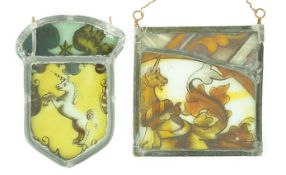 Two 17th century stained glass fragment panels, each depicting a unicorn, 13 x 12cm and 14 x