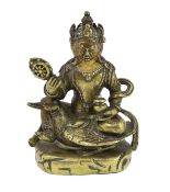 * * A Tibetan gilt bronze figure of a bodhisattva, 17th century, with four faces, holding a wheel