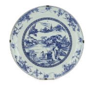 A Chinese blue and white landscape dish, Yongzheng/Qianlong period, finely drawn and painted with