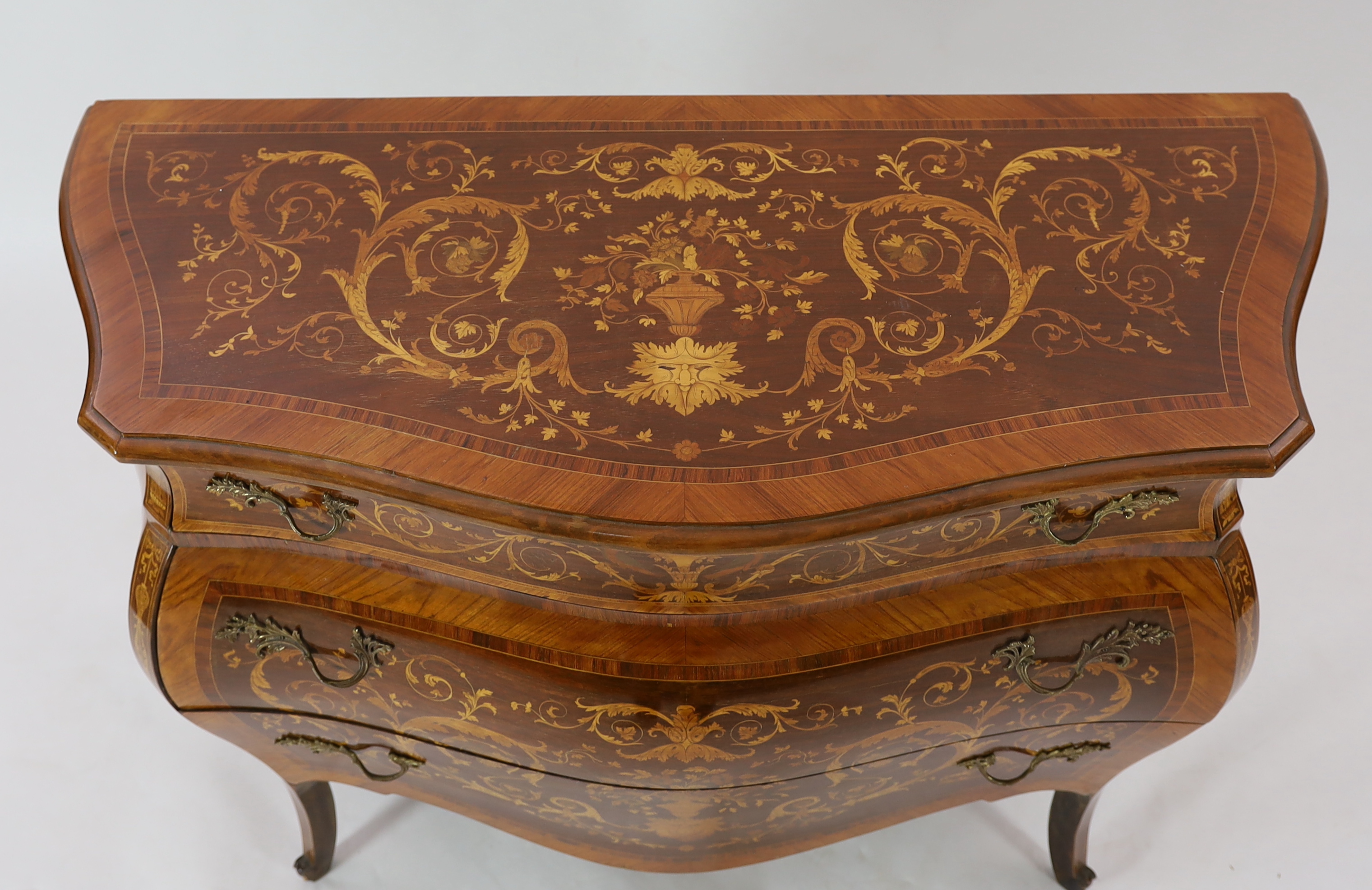 A Continental marquetry inlaid serpentine bombé commode, fitted three long drawers, on scroll - Image 3 of 4