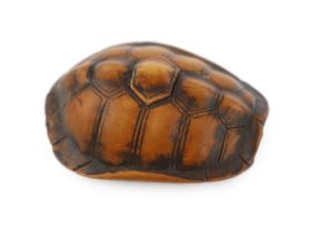 * A Japanese carved wood netsuke of a turtle shell, mid 19th century, the upper part of the