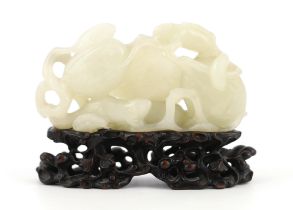 * A Chinese white jade carving of a cluster of melons, 18th century, with stalks and leaves, two