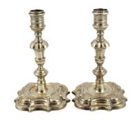 * A pair of George II cast silver candlesticks, by Richard Gosling, with engraved crest and