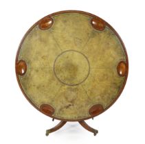 A Regency style mahogany gaming table, the moulded circular top inset with a worn green leather