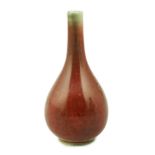 A Chinese copper red small bottle vase, 18th/19th century, of pear shape, underglaze blue double