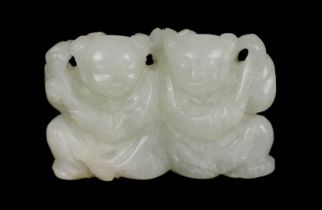 * A Chinese pale celadon jade carving of the He He Erxian twins, 18th/19th century, one boy