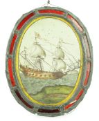 An early 18th century stained glass panel, depicting a warship off the coast, within a later red
