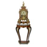 A Louis XV style brass mounted red boulle mantel clock on matching stand, with Britannia finial,