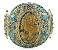 A Chinese silver-gilt, enamel and tiger's-eye bracelet, early 20th century, head 68mm by 65mm, gross
