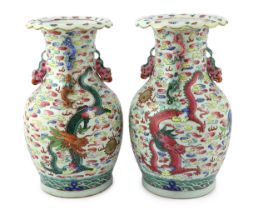 A pair of Chinese enamelled porcelain 'dragon and Buddhist lion' vases, 19th century, each painted
