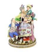 A Meissen group The Good Mother, 19th century, with good detail to the clothing, playing cards and