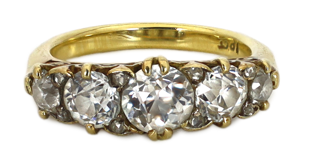 An early 20th century 18ct gold and graduated old round cut diamond set half hoop ring, with diamond