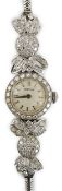 A lady's mid 20th century platinum and round cut diamond set Vertex manual wind cocktail watch, with