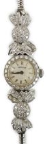 A lady's mid 20th century platinum and round cut diamond set Vertex manual wind cocktail watch, with