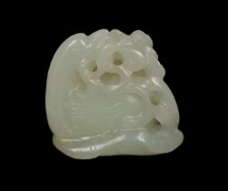 * A Chinese small white jade carving of a stylised duck, late Qing dynasty, clasping a sprig of