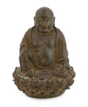 A Chinese lacquered bronze figure of Budai, late Ming dynasty, the figure seated on a lotus