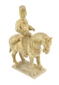 * * A Chinese cream glazed pottery model of an archer on horseback, Tang Dynasty (618-906 AD),