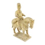 * * A Chinese cream glazed pottery model of an archer on horseback, Tang Dynasty (618-906 AD),