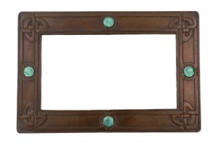 A Liberty Arts & Crafts embossed copper and 'Ruskin stone' wall mirror, designed by Archibald