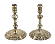 * A pair of George II cast silver tapersticks, by James Gould, on domed foot, London, 1734, 10.