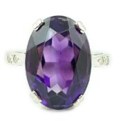 An 18ct white gold and oval cut amethyst set ring, with two stone diamond chip set shoulders, size