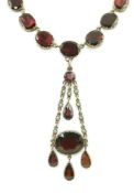 An early 19th century gold, and thirty five graduated foil backed garnet set necklace, with later