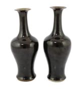 A near pair of Chinese mirror-black glazed vases, Kangxi period, each with a trumpet shaped neck