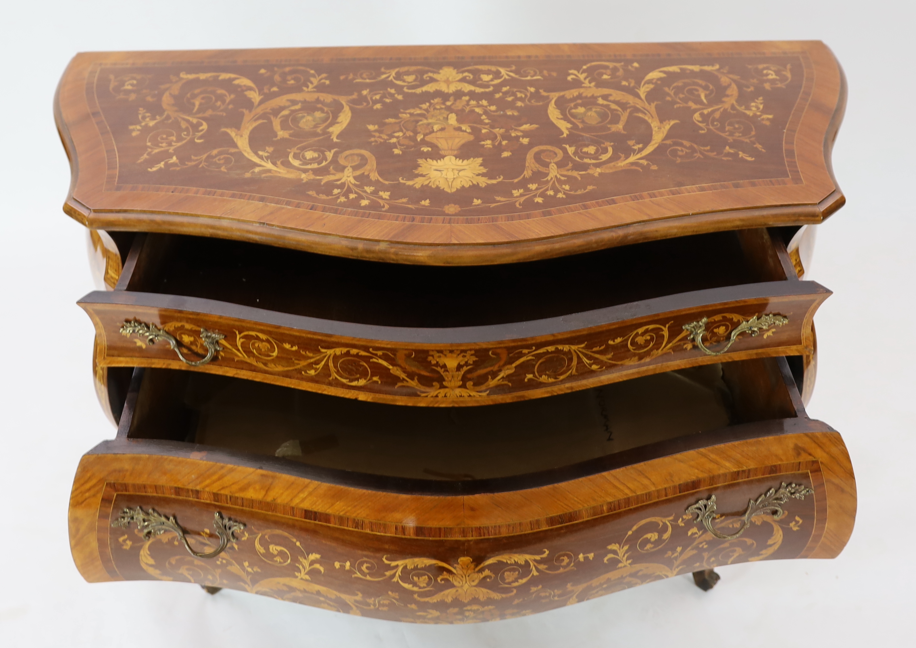 A Continental marquetry inlaid serpentine bombé commode, fitted three long drawers, on scroll - Image 4 of 4