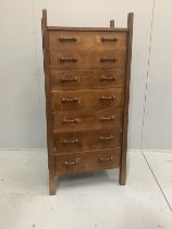 An Arts & Crafts oak seven drawer chest by Lawrence Tweedie of Derbyshire, width 67cm, height